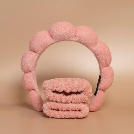 Coral ROYAL hair care headband and matching fabric wristbands displayed together against a beige background.