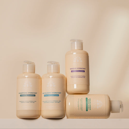 ROYAL Hydrating Shampoo, Hydrating Conditioner, Hydrating Mask and 10 in 1 Leave-In Conditioner arranged together against a minimalist beige background.