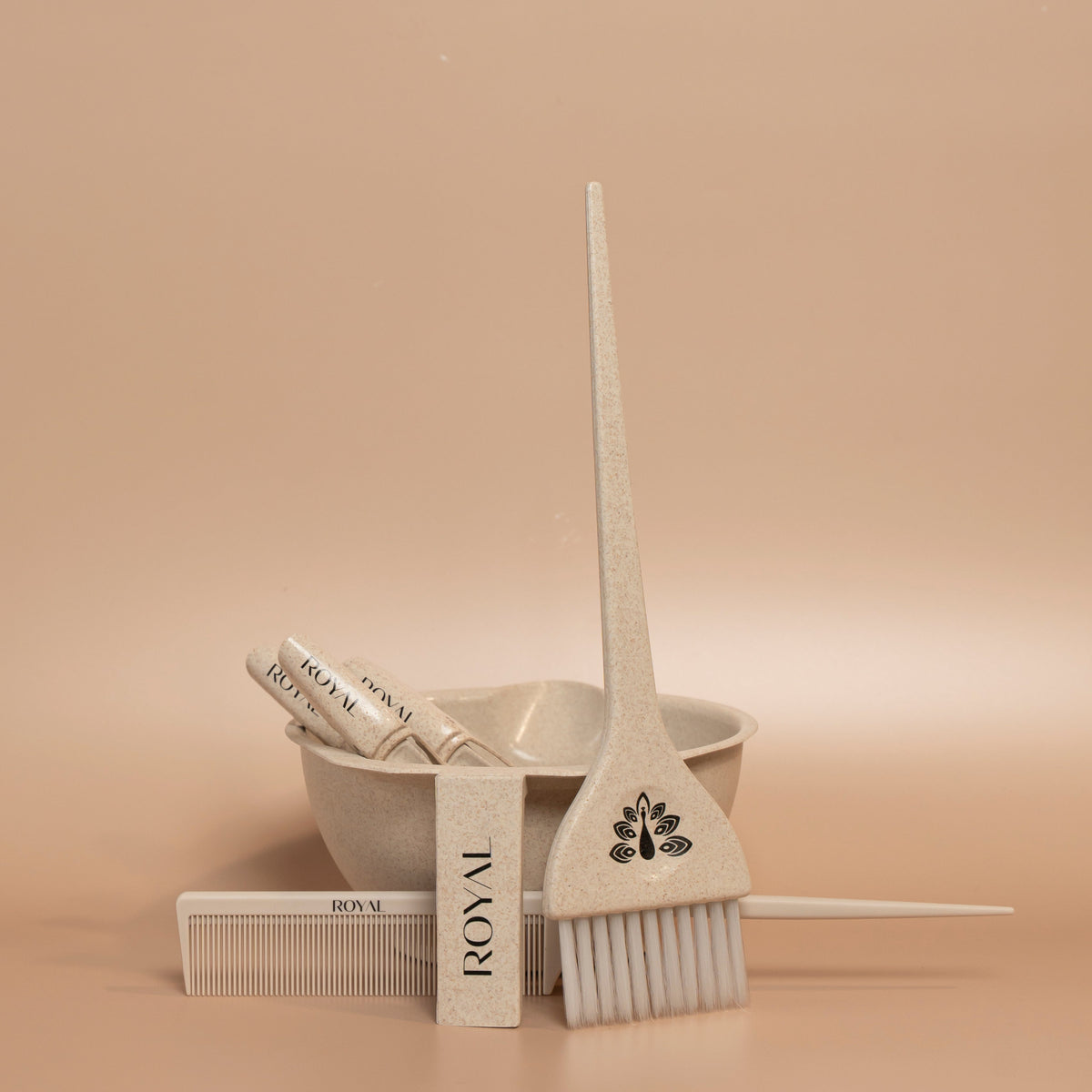 ROYAL professional application kit featuring a mixing bowl, application brush, comb and sectioning clips on a warm beige background.