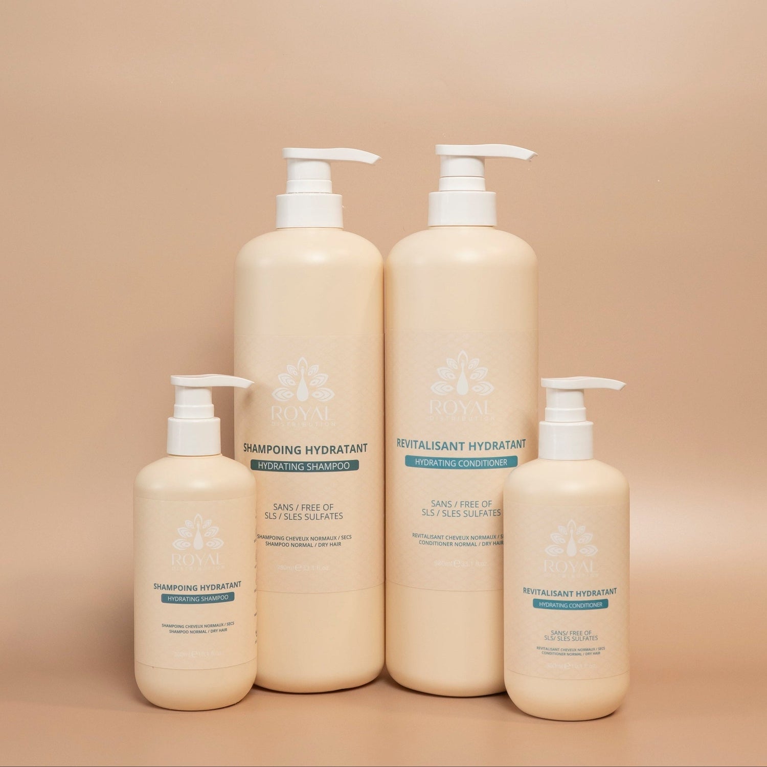 Four ROYAL Hydrating hair care bottles arranged together against a beige background, featuring the 300 ml and 980 ml shampoos and conditioners.
