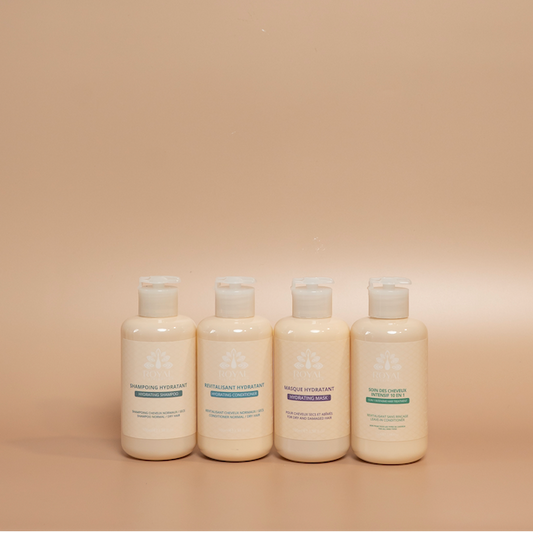 ROYAL Hydrating Travel Hair Care Set featuring 100 ml Hydrating Shampoo, Conditioner, and Hair Mask, plus a 75 ml Intensive 10-in-1 Hair Care, photographed against a beige background.