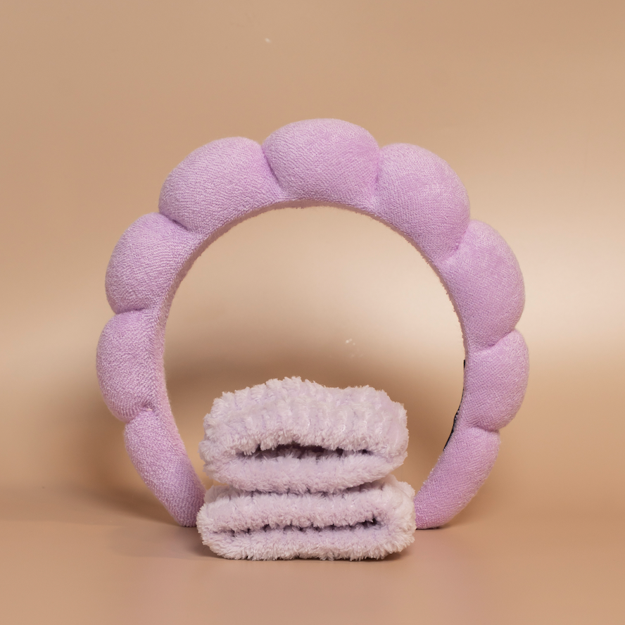 Lilac ROYAL hair care headband and matching fabric wristbands displayed together against a beige background.