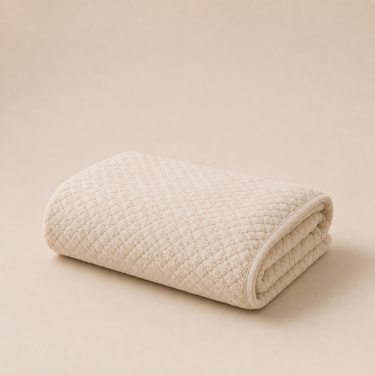 ROYAL beige microfiber hair towel neatly folded on a neutral beige background, highlighting its ultra-soft texture and delicate fabric finish for gentle hair drying.