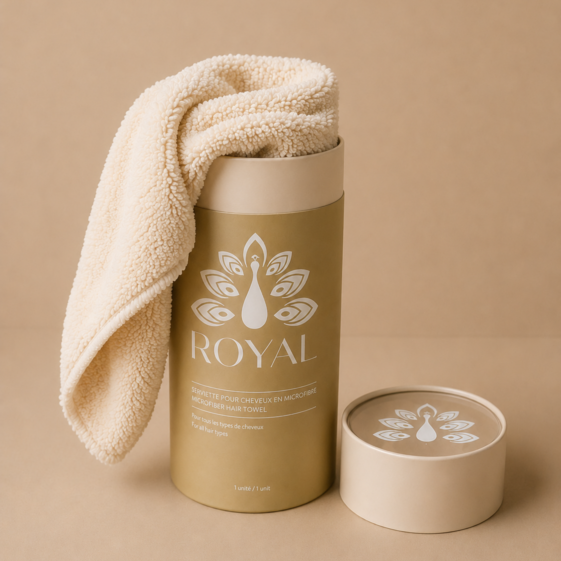 ROYAL soft beige microfiber hair towel draped over its luxurious gold packaging, showcasing its plush texture and gentle hair care design.
