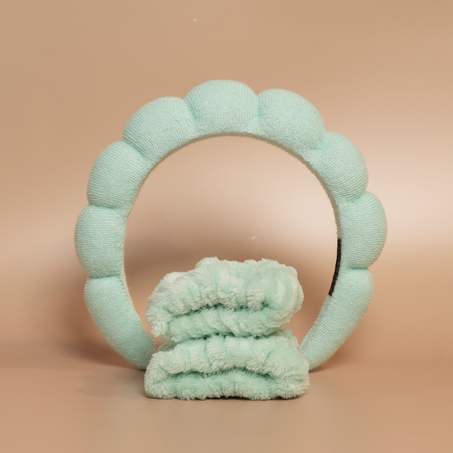 Mint ROYAL hair care headband and matching fabric wristbands displayed together against a beige background.
