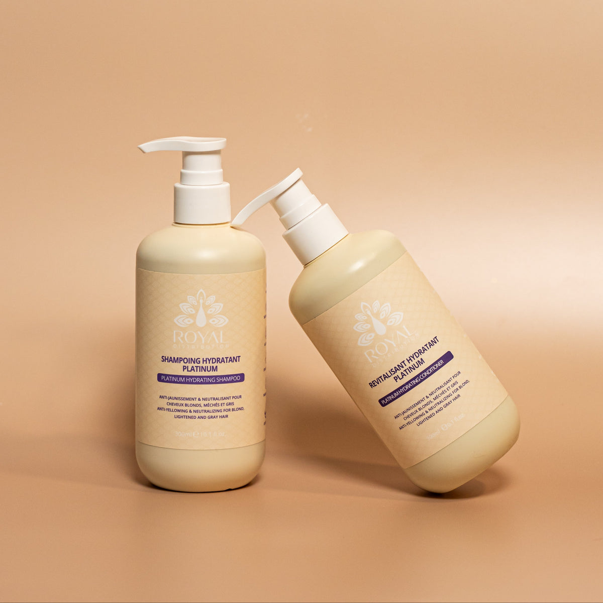 ROYAL Platinum Hydrating Shampoo and Conditioner in 300 ml pump bottles, styled together against a warm beige studio background.