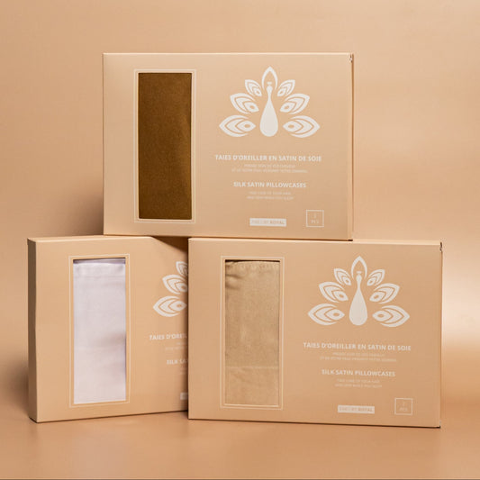 Three ROYAL silk satin pillowcase boxes displayed together against a beige background, with the pillowcases inside.