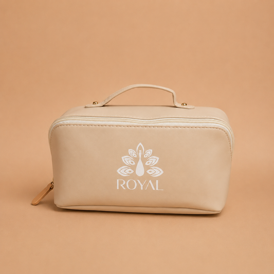 Front view of a beige ROYAL travel haircare bag with a top handle, zipper closure, and white logo on a warm beige background.